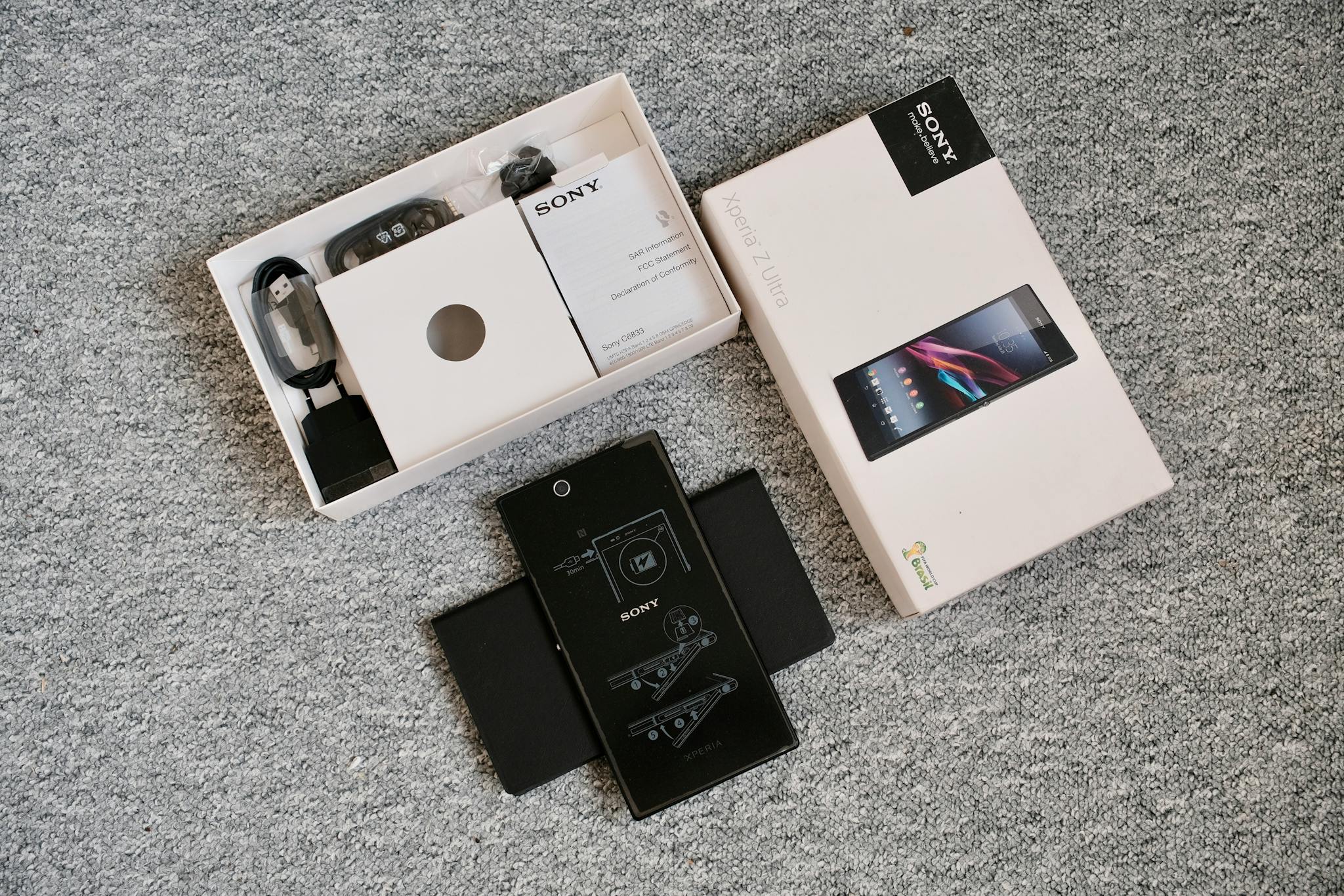 Detailed unboxing image of a mobile phone and its accessories, perfect for tech blogs.